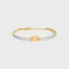 Bracciale articolato Triomphe in smalto e ottone con finitura dorata Bracciale articolato Triomphe in smalto e ottone con finitura dorata