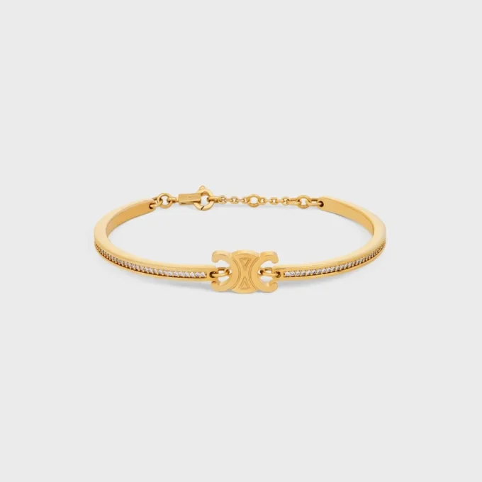 Bracciale articolato Triomphe Sparkle in strass e ottone con finitura dorata Bracciale articolato Triomphe Sparkle in strass e ottone con finitura dorata