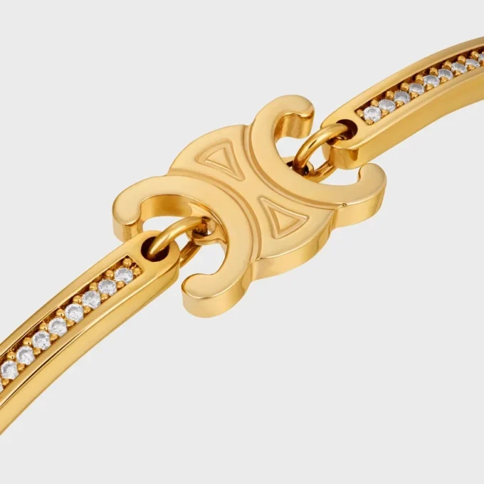 Bracciale articolato Triomphe Sparkle in strass e ottone con finitura dorata Bracciale articolato Triomphe Sparkle in strass e ottone con finitura dorata