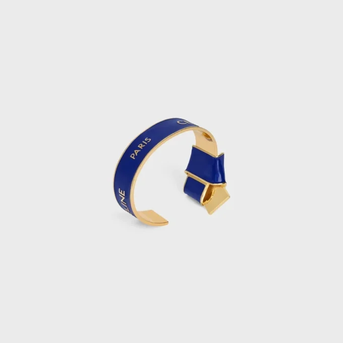 Bracciale rigido CELINE con nodo in smalto e ottone con finitura dorata Bracciale rigido CELINE con nodo in smalto e ottone con finitura dorata
