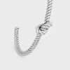 Bracciale rigido con motivo a cordino annodato in ottone con finitura al rodio