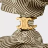 Elastico per capelli CELINE Triomphe Diagonale in seta e ottone con finitura dorata Elastico per capelli CELINE Triomphe Diagonale in seta e ottone con finitura dorata