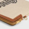 Piccola pochette con tracolla in tessuto con ricamo a forma di ancora e pelle di vitello Piccola pochette con tracolla in tessuto con ricamo a forma di ancora e pelle di vitello