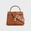 Tracolla lunga in lana con motivo jacquard CELINE e finiture dorate Tracolla lunga in lana con motivo jacquard CELINE e finiture dorate